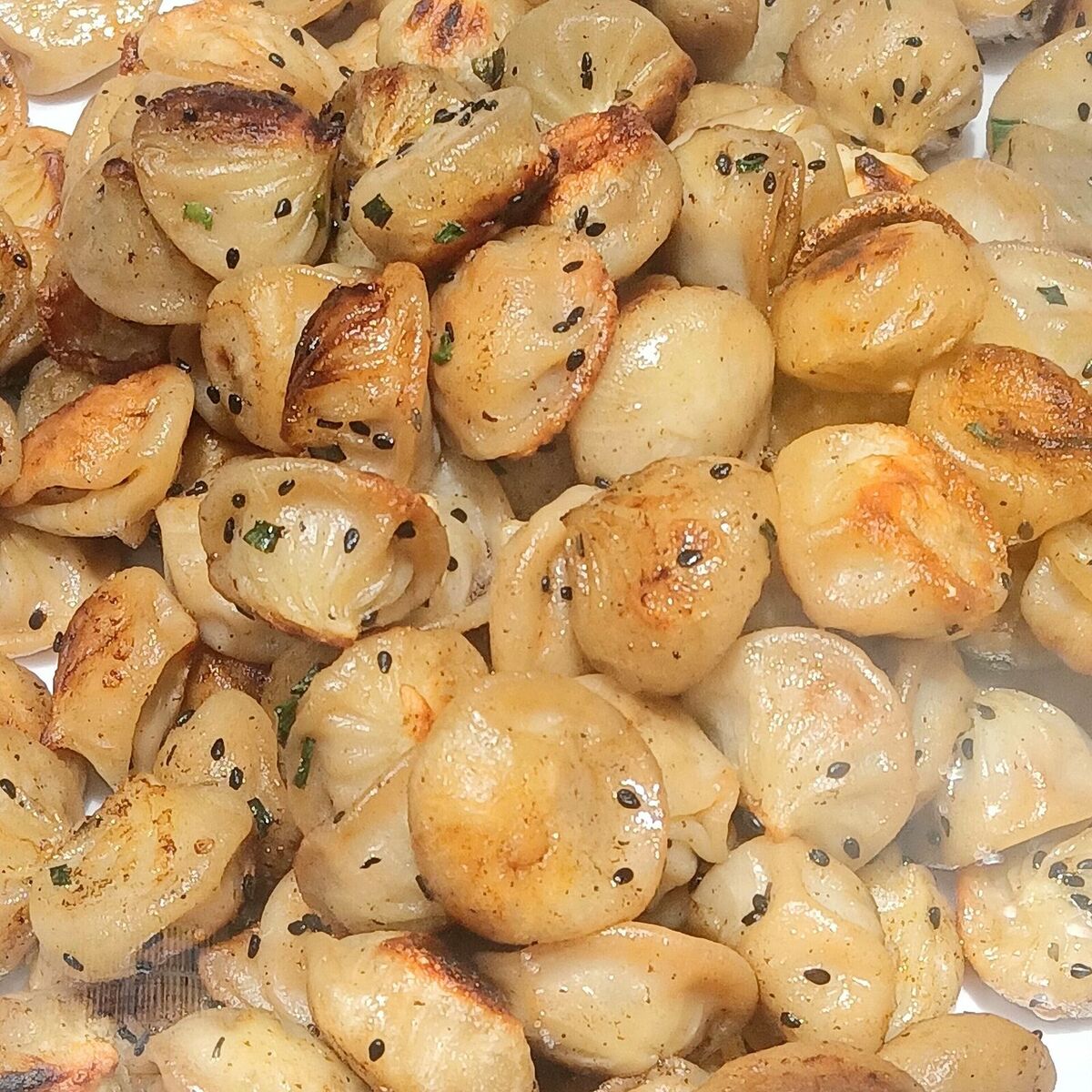 Illustrative photo of pan-fried buns sprinkled with sesame