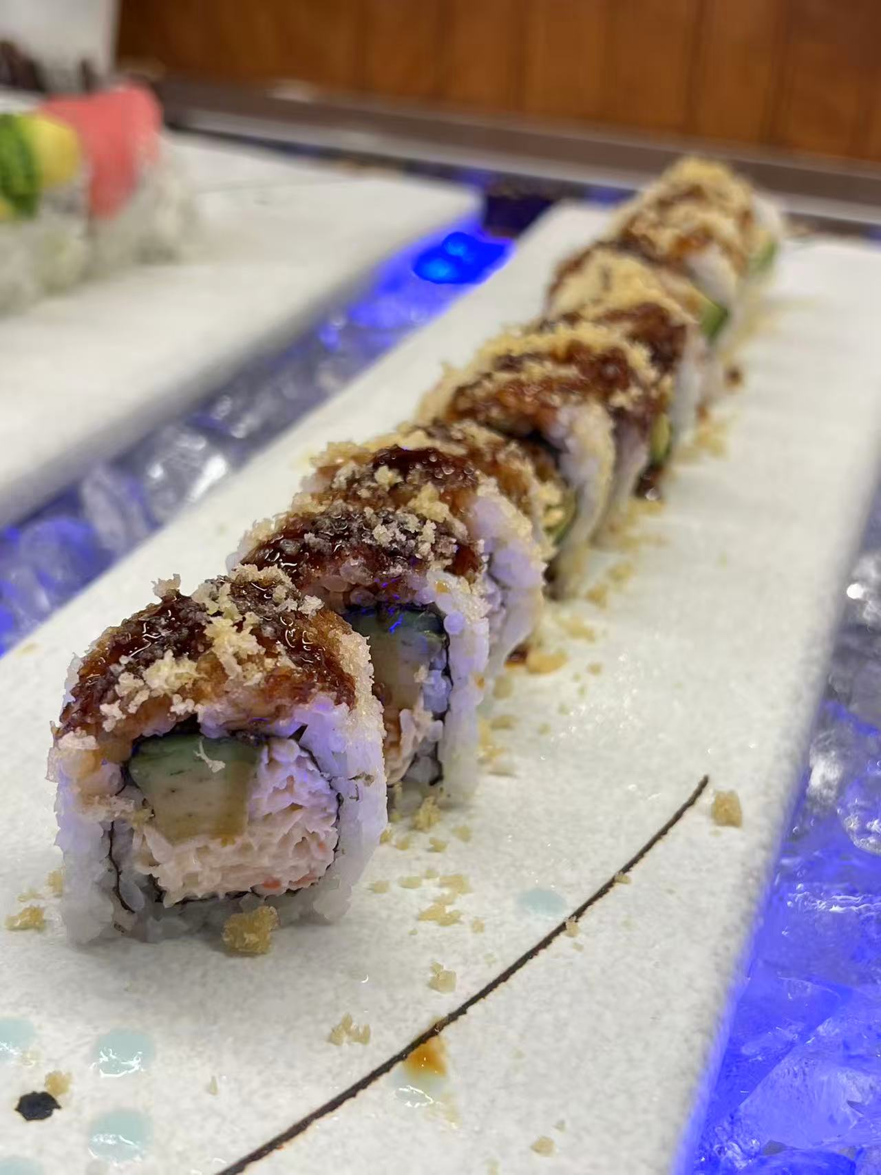 Crunch-topped sushi rolls on the chilled buffet counter at Kyushu Buffet