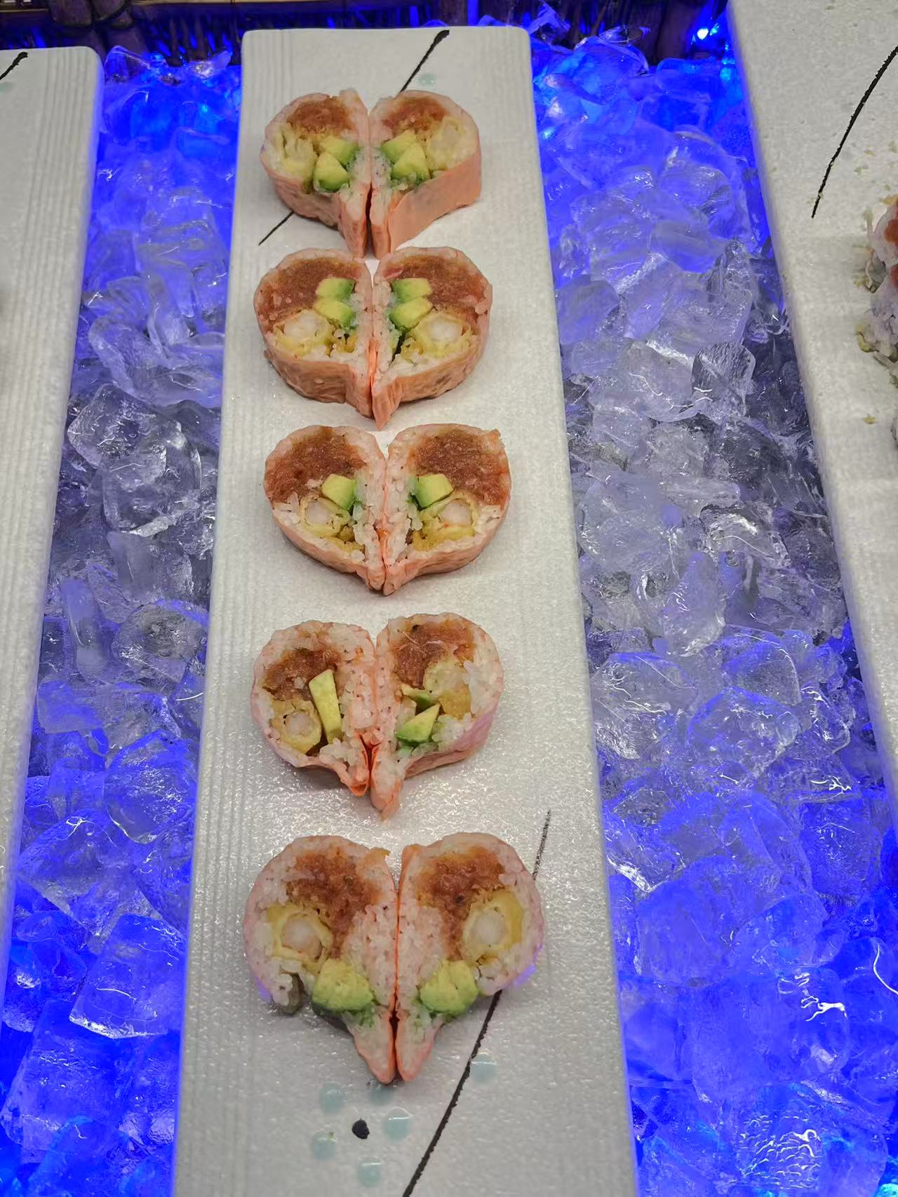 Pink-wrapped sushi rolls with avocado on the Kyushu Buffet counter